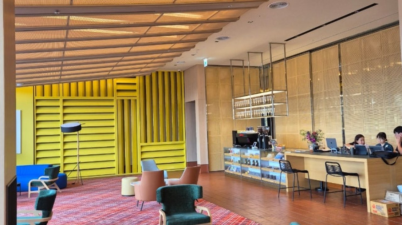 The Coolist Hotel Songjeong designer lobby with yellow slatted walls and coffee bar