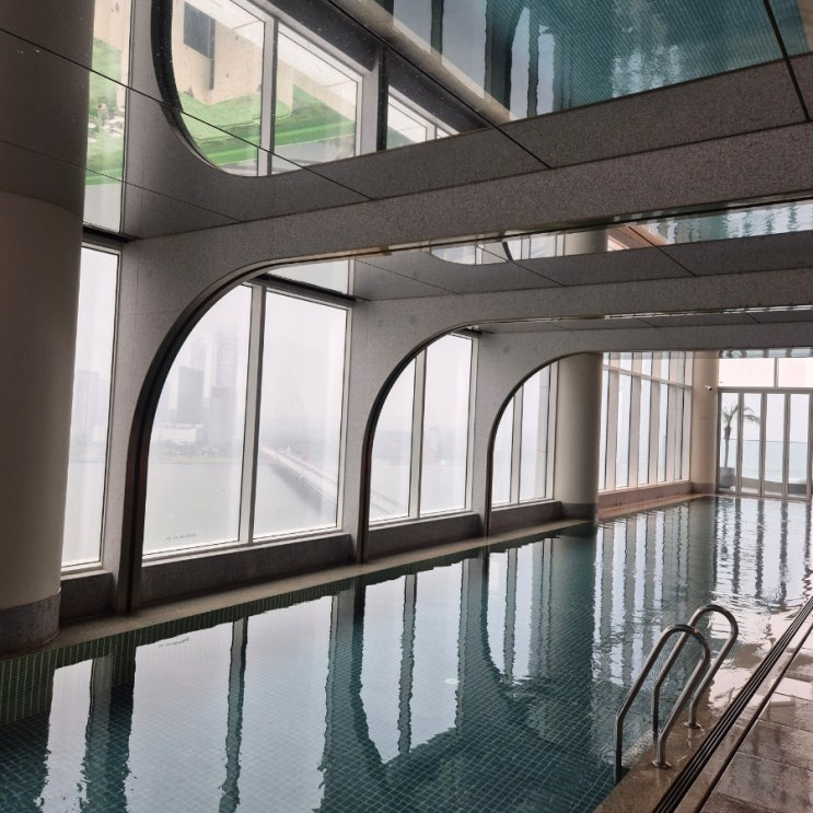 Hotel Naru Seoul M Gallery pool with arched windows and Han River skyline