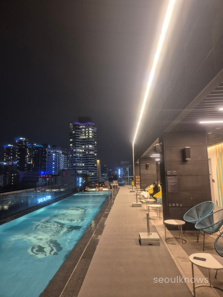 Pool deck with city and beach views.