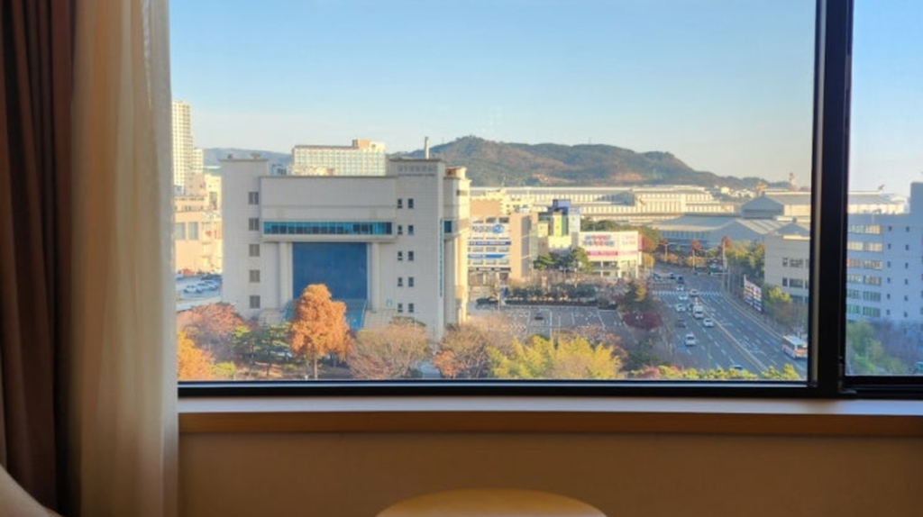 Hotel Hyundai by Lahan Ulsan room view of Hyundai Department Store and autumn mountains