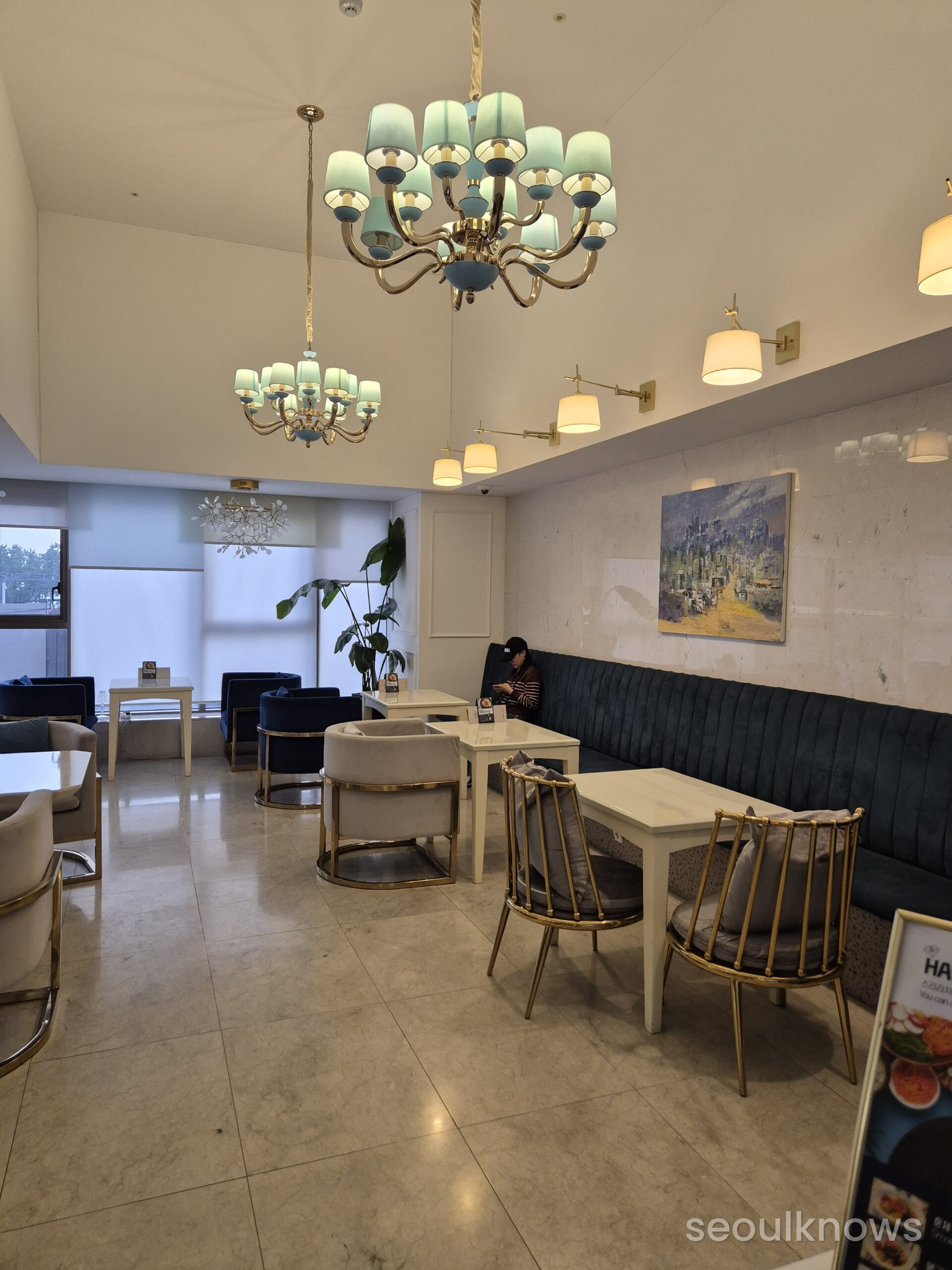 Baymond Hotel lobby with grand chandelier