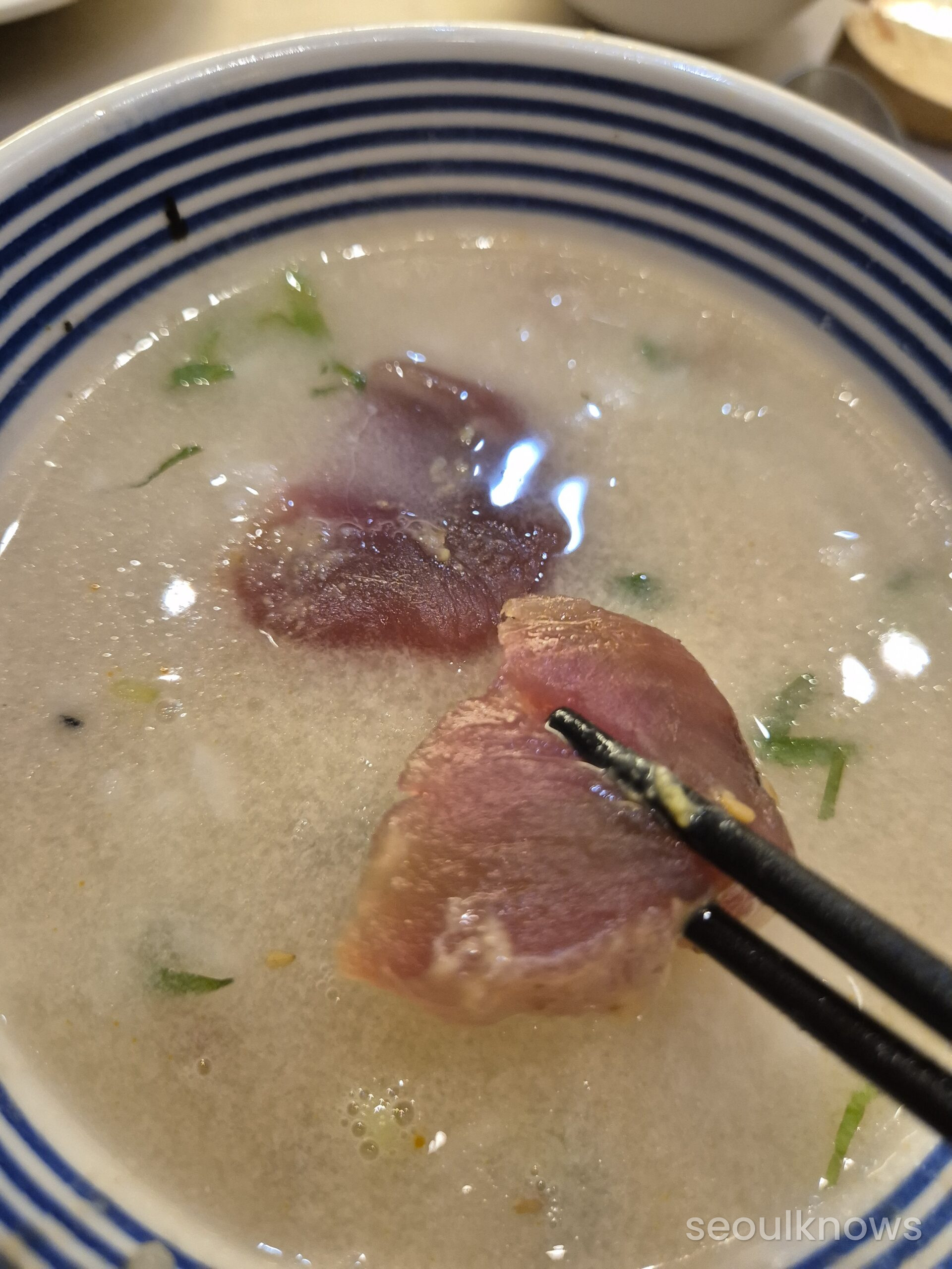 Tuna sashimi dropped into the ochazuke broth at Giyohan Haeundae