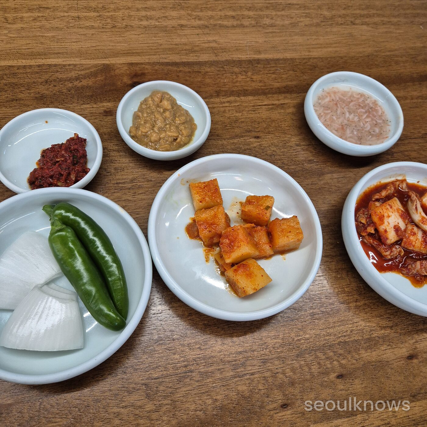 Side dishes at Gukdong Dwaeji-Gukbap including kkakdugi and salted shrimp
