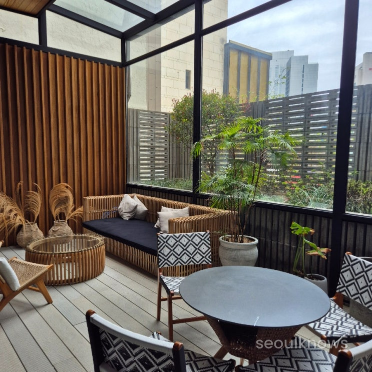 Glass-walled garden lounge at Hound Garden & Terrace Haeundae