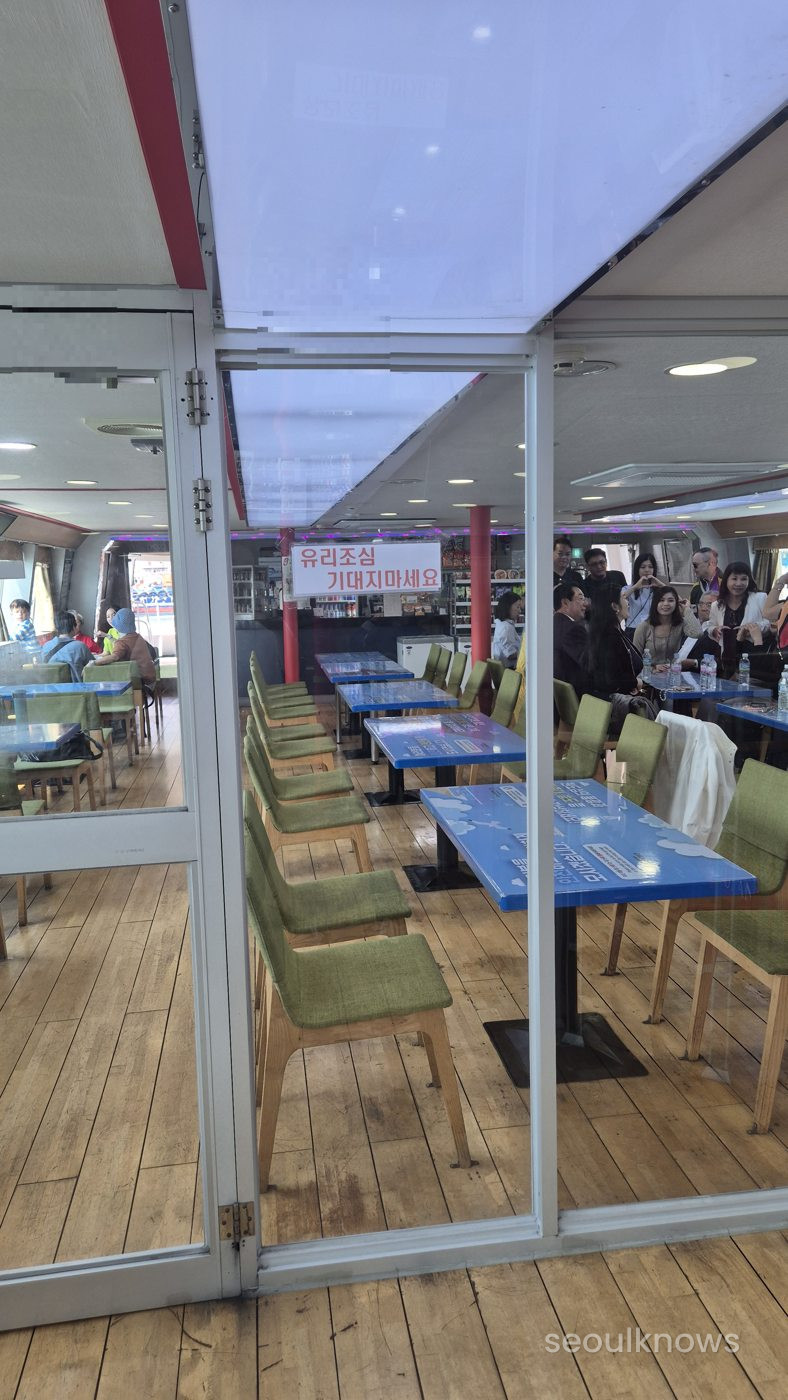 Glass-walled cabin seating on the Jagalchi Cruise