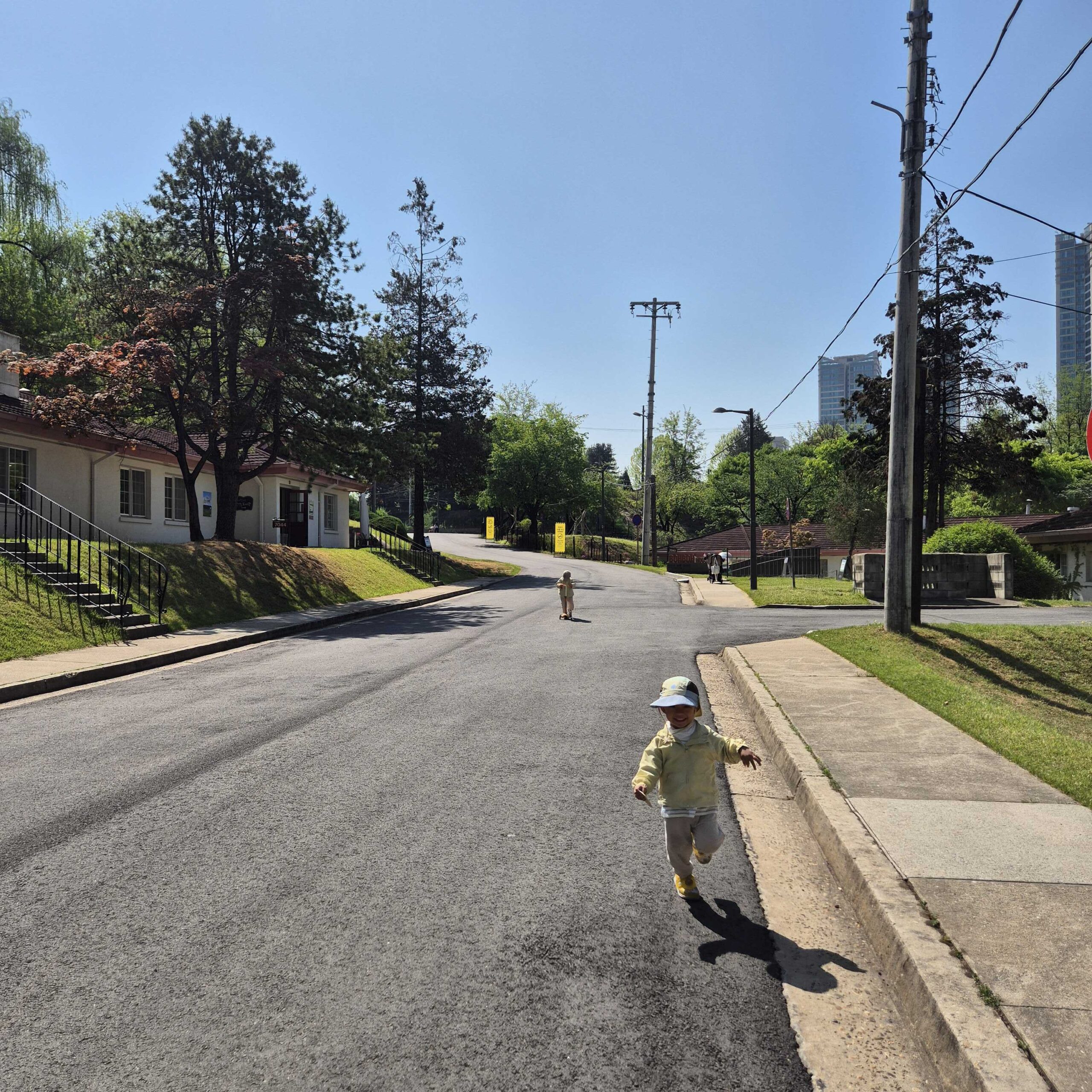 A child running through the former U.S. military housing lanes at Yongsan Family Park in spring