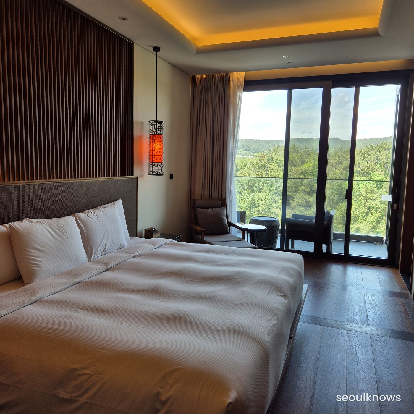Ananti Cove Cabin guest room with a full bed and warm wood-tone interior
