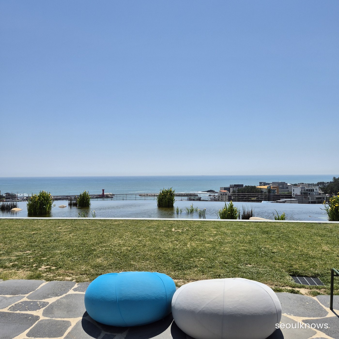 Lawn with cushions by the ocean at Ananti Cove