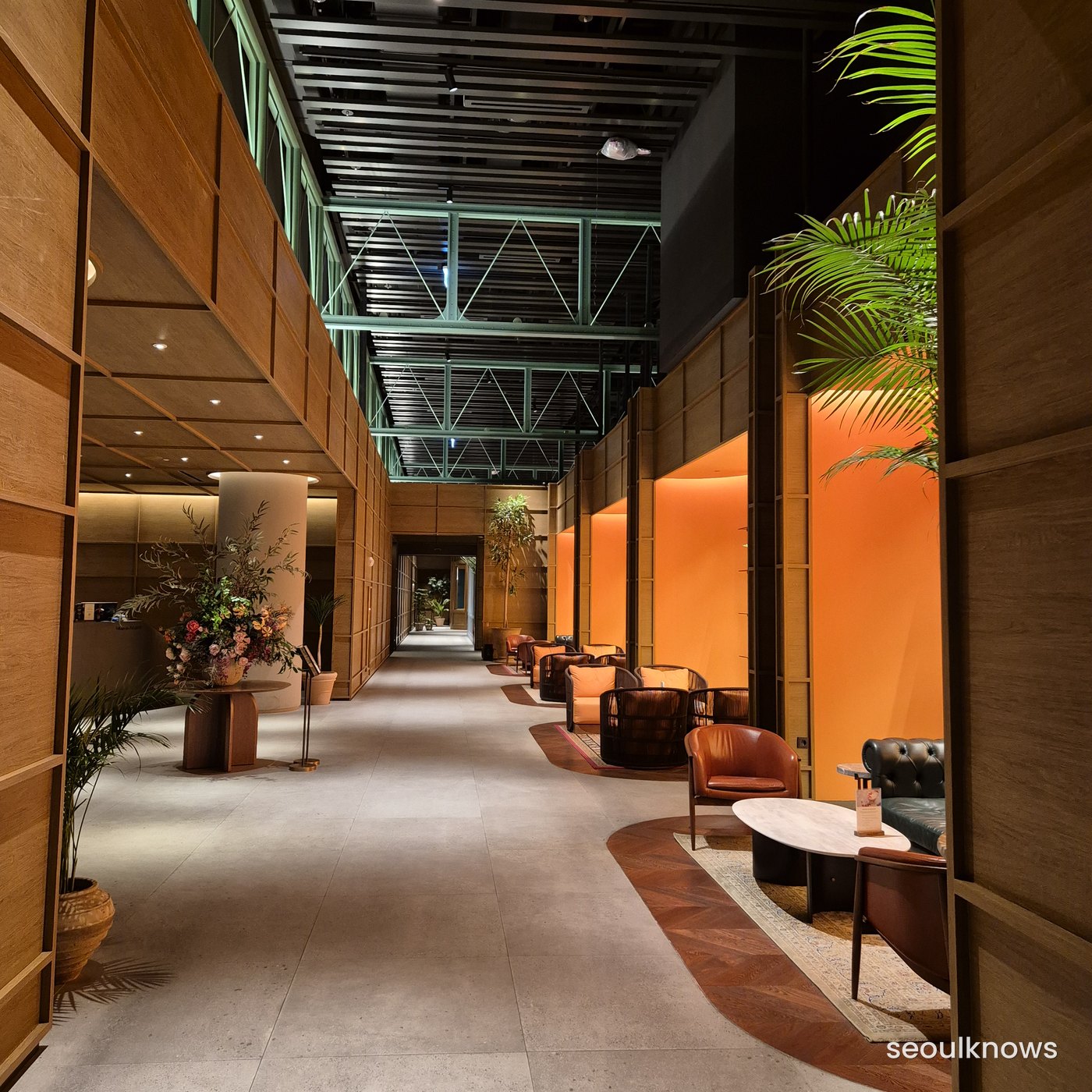 Orange lounge and shop corridor at Village de Ananti Square
