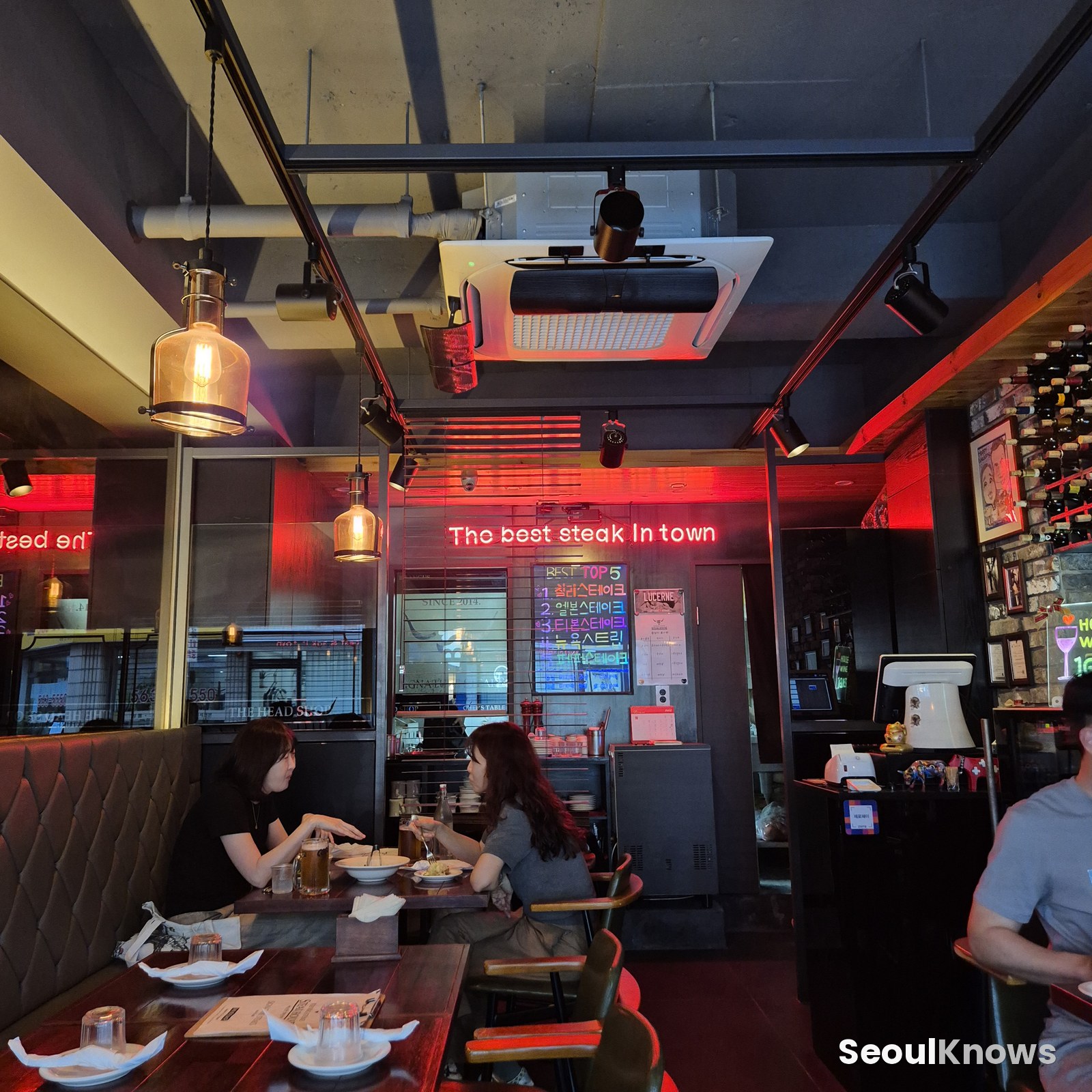 Warm red-lit interior of Burning Stone steakhouse