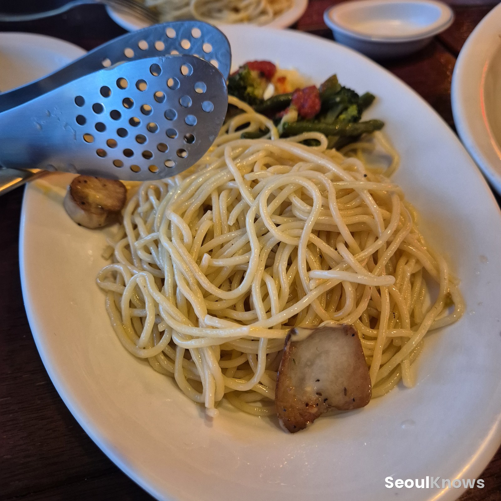 Garlic pasta and vegetables served with the steak