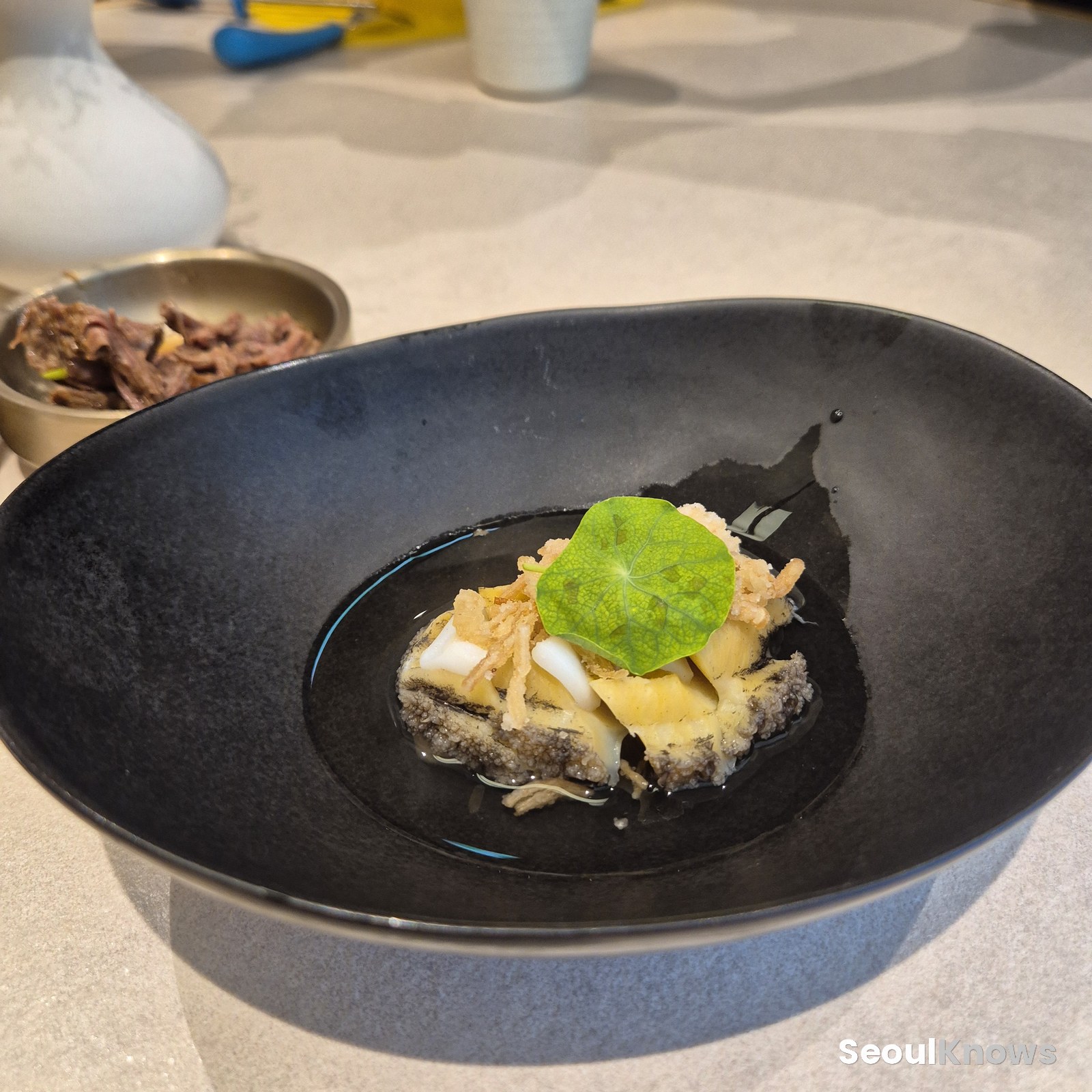 Steamed abalone dish with green garnish