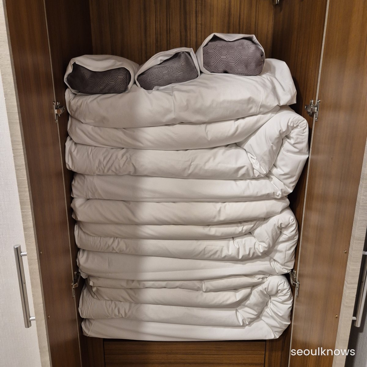 Neatly stacked bedding sets in the ondol room