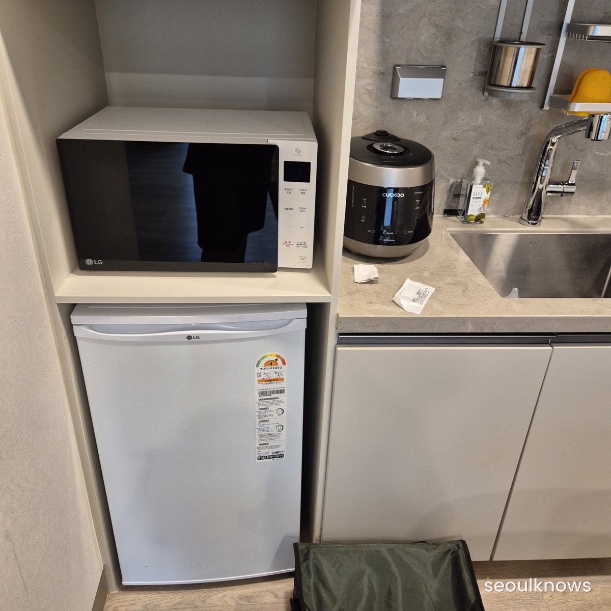 Microwave, rice cooker and mini fridge in the condo kitchen