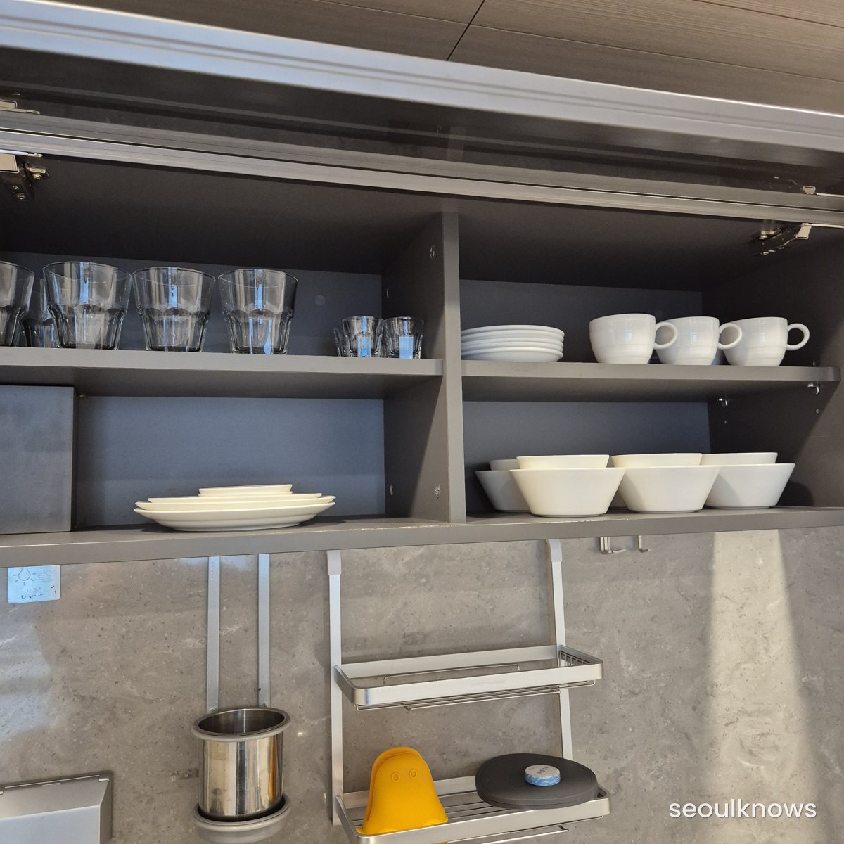 Cupboard stocked with cups, plates and bowls