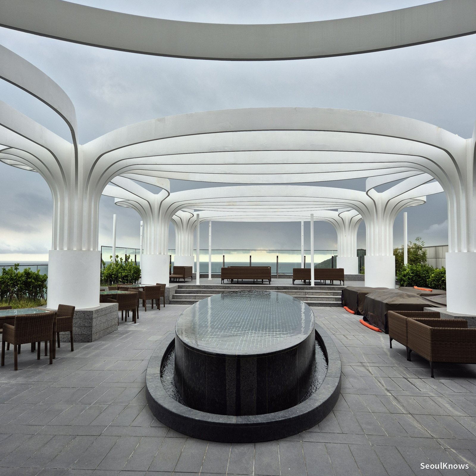 Open-air rooftop terrace with white arches at McQueens Grill and Bar