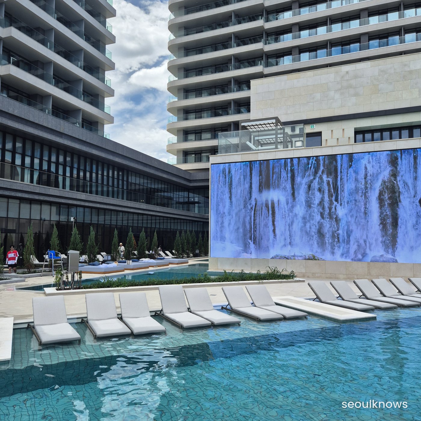 Residence outdoor pool with a giant LED waterfall screen