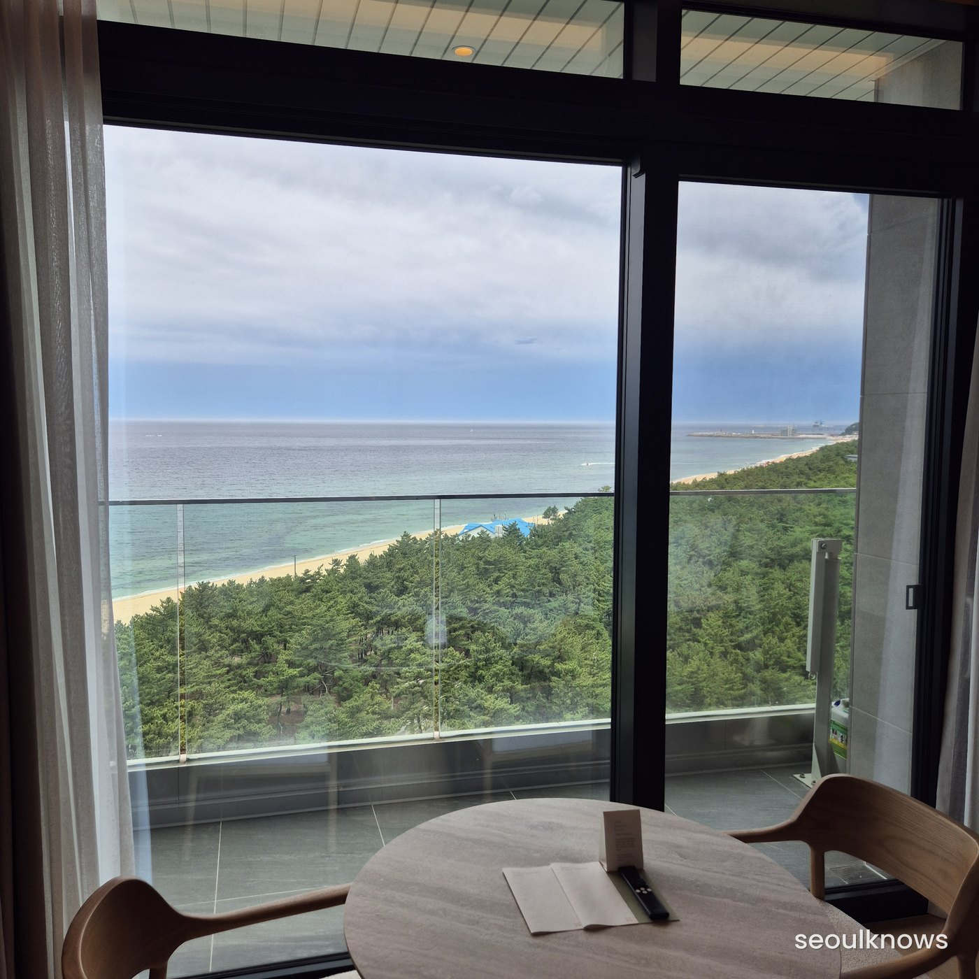 Curtains open to a full East Sea view