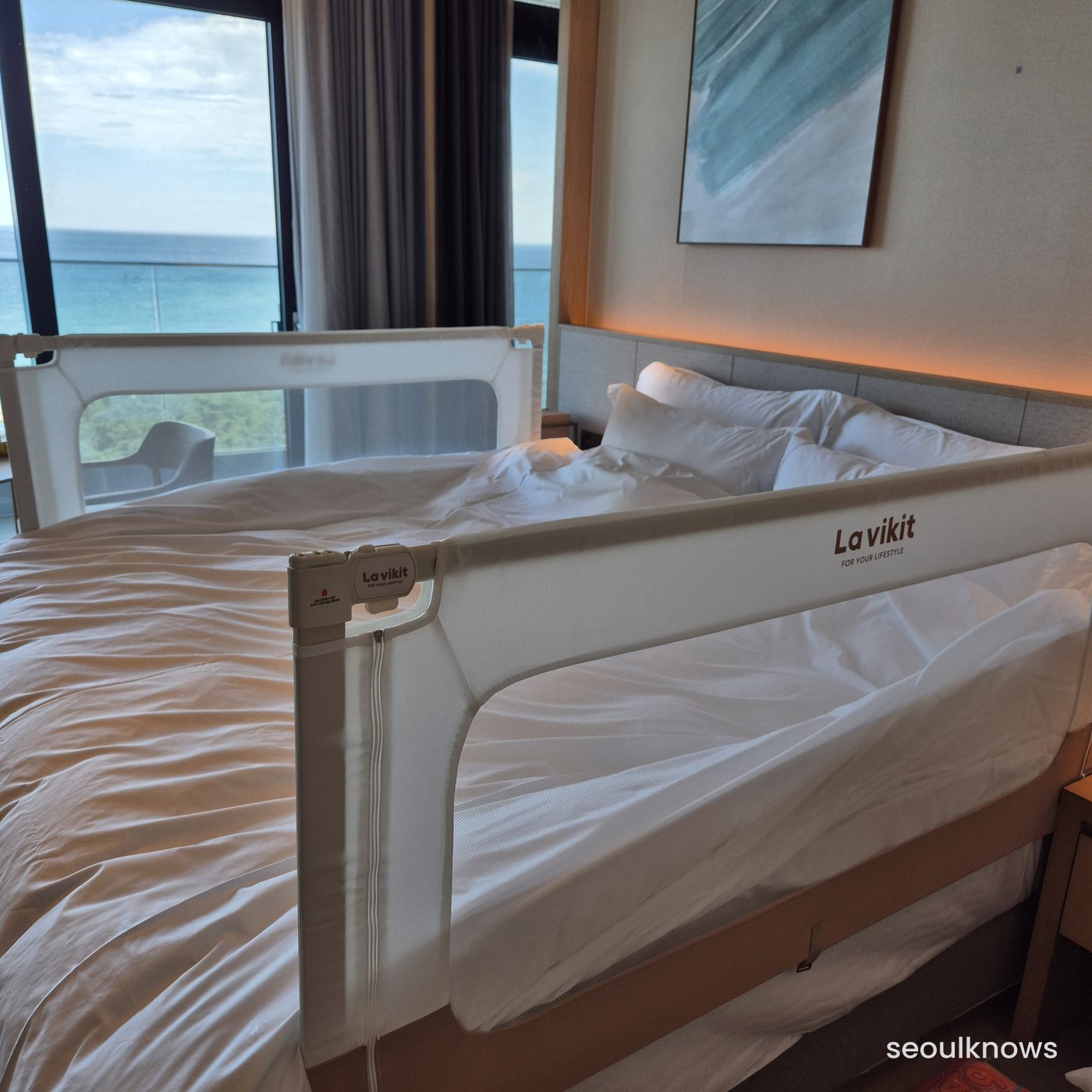 Bed with a bed guard for infants