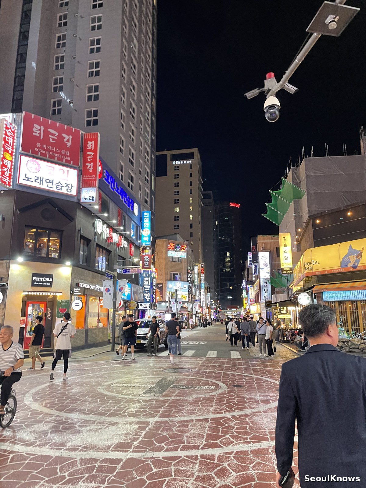People walking through a busy Seoul nightlife street