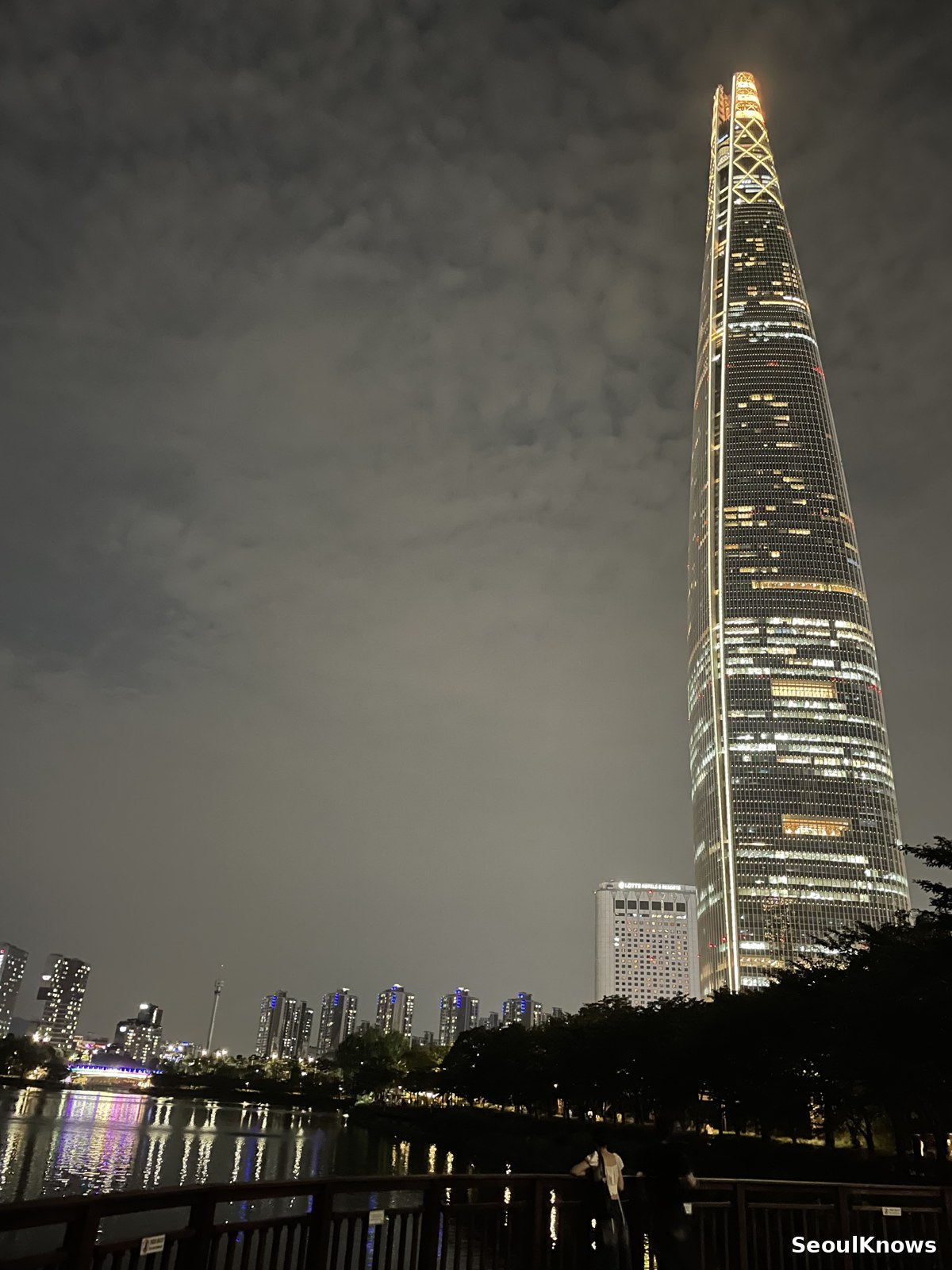 Lotte World Tower seen across Seokchon Lake at night