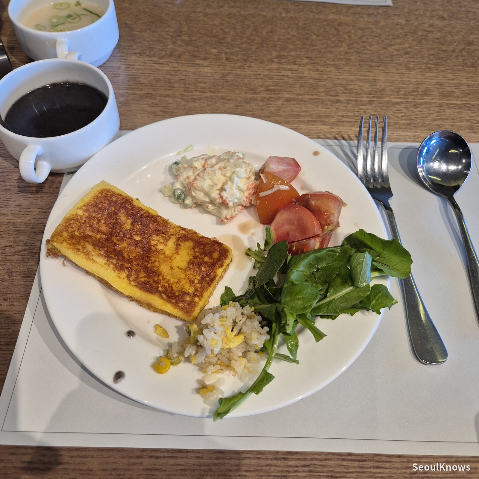 A breakfast plate with French toast and salad
