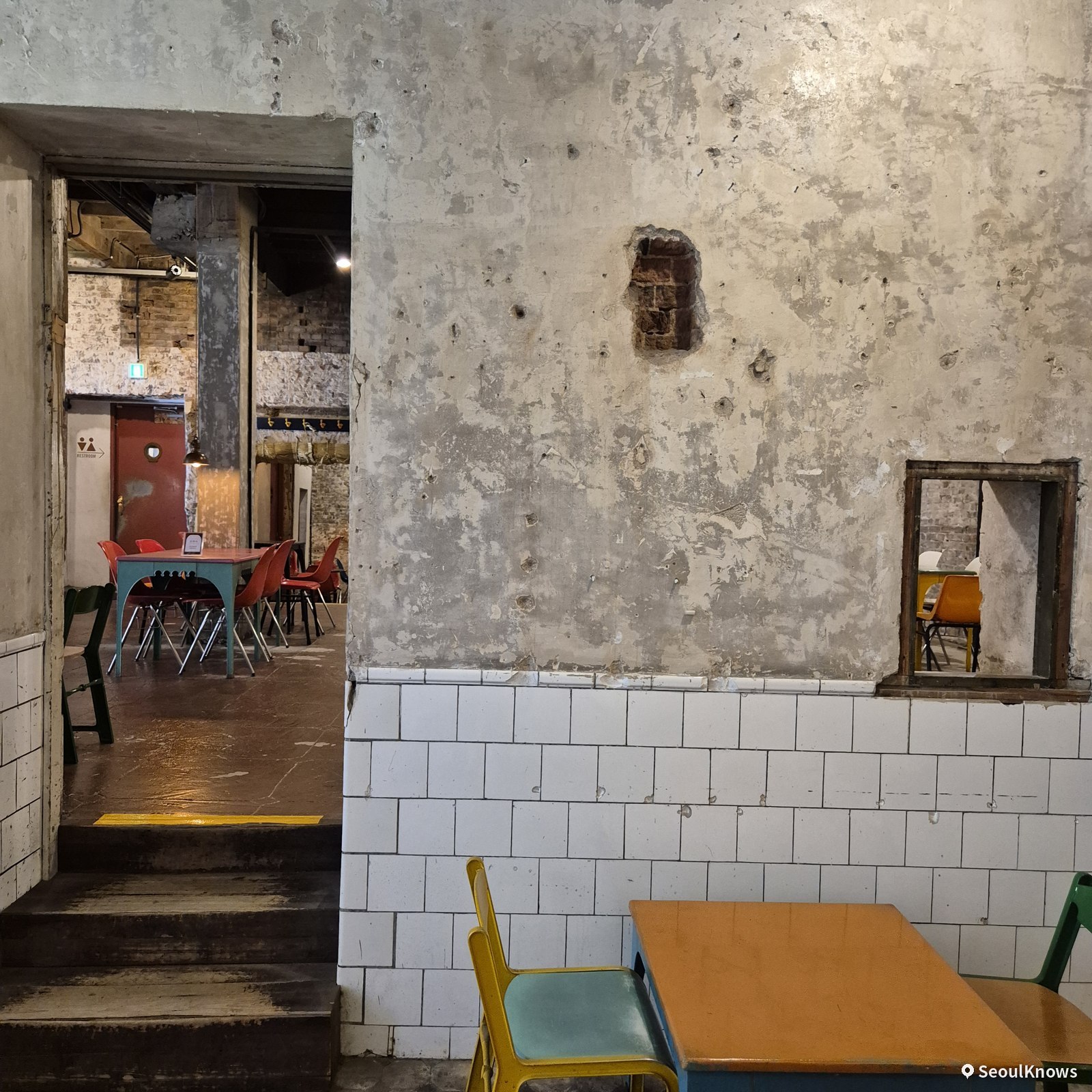 White-tiled walls and steps inside the heritage building cafe