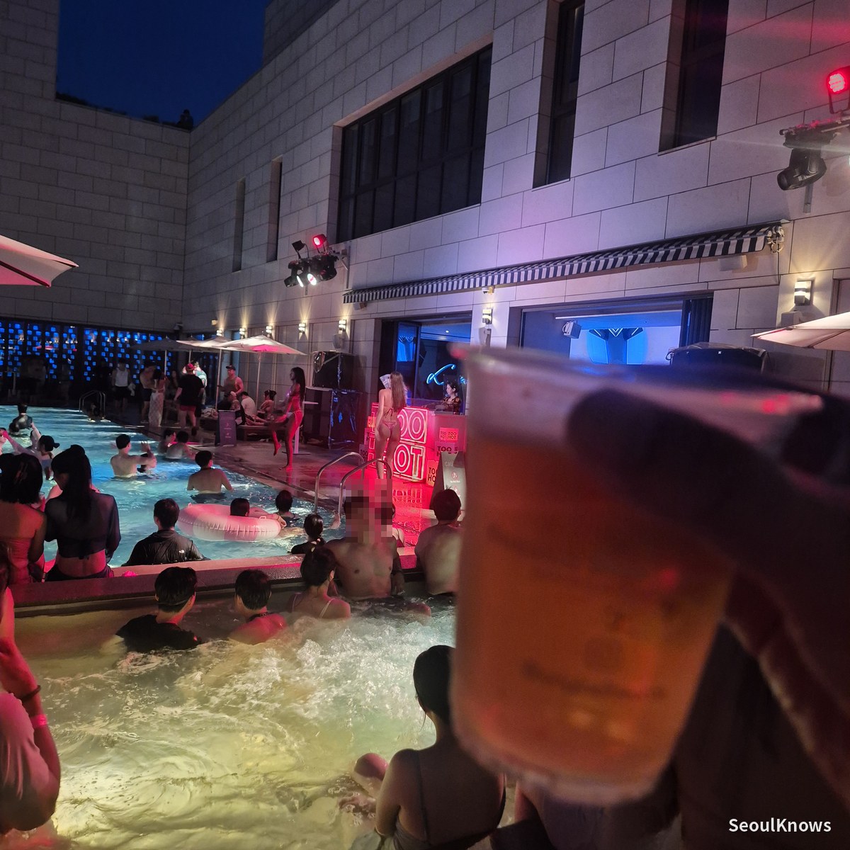 Holding up a beer in the heated outdoor pool at Cimer pool party