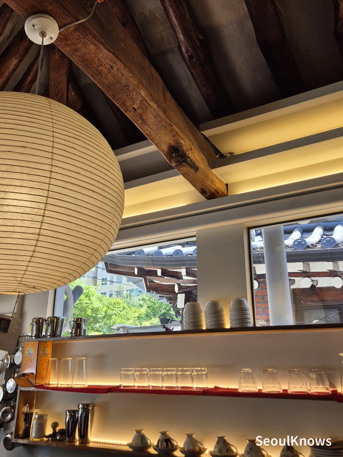 Exposed rafters and paper lanterns in the hanok ceiling