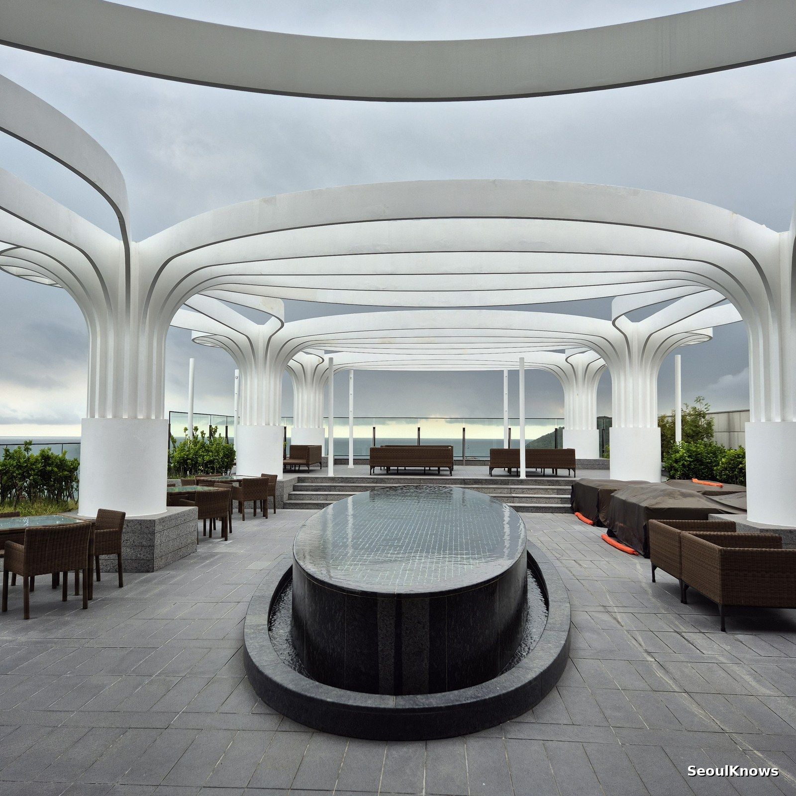 Open-air rooftop terrace with white arches at McQueens Grill and Bar
