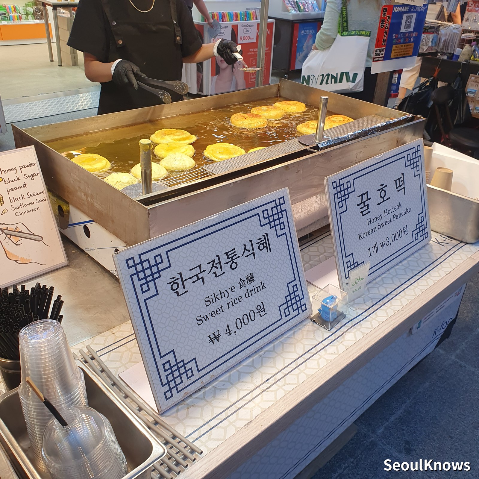 Hotteok sweet filled pancakes on a griddle