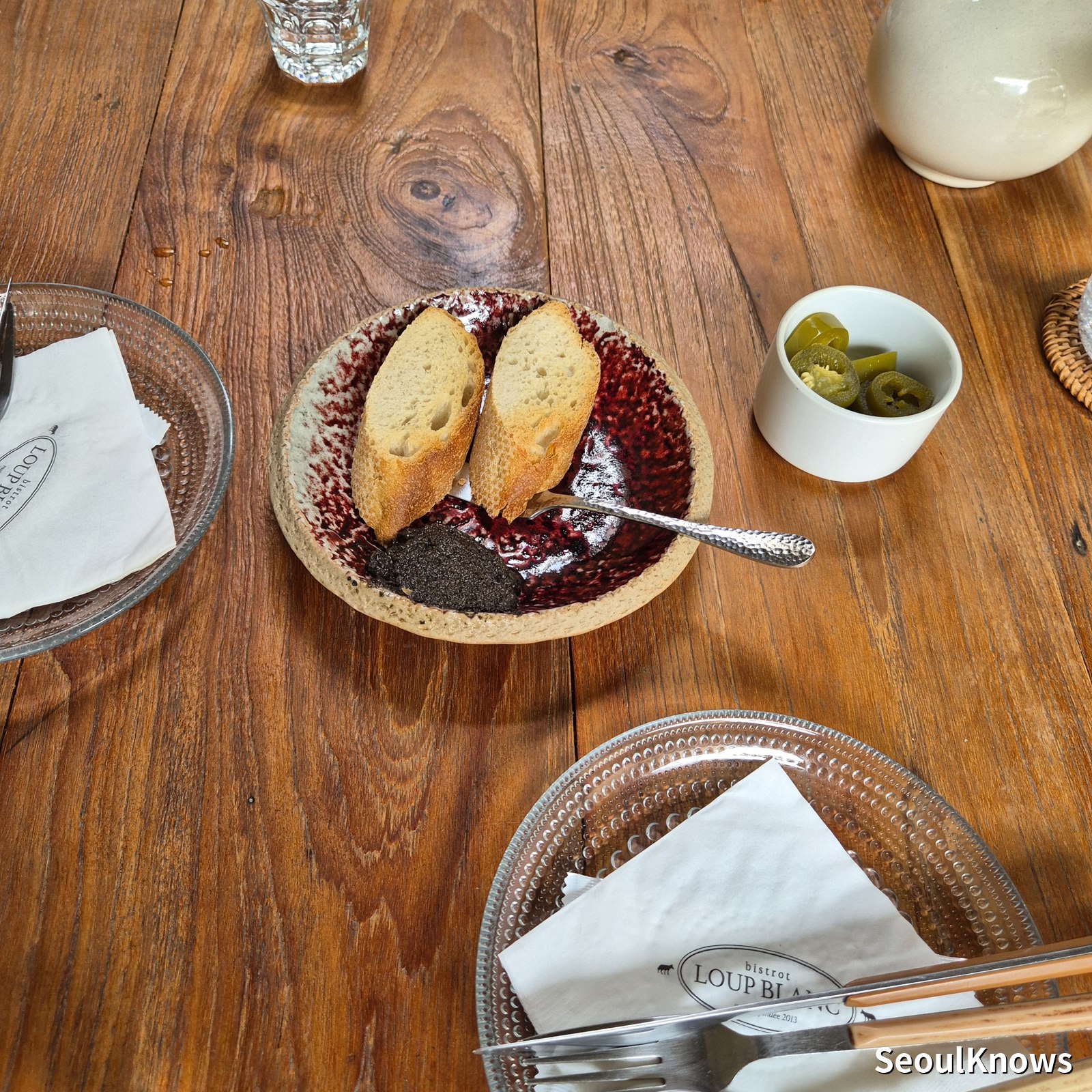 Maison Leblanc bread service with spreads and pickles