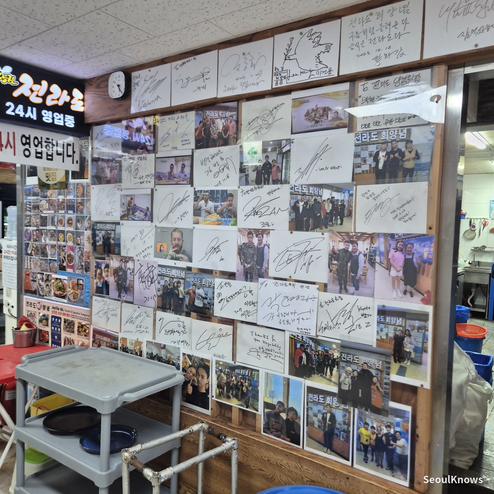 Wall of visitor photos and a 24-hour opening notice