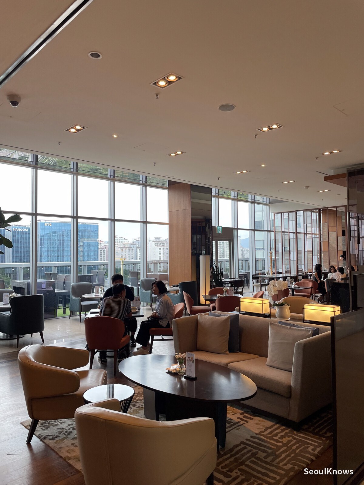 Lounge sofa and bookshelf detail in the Pangyo Courtyard lobby