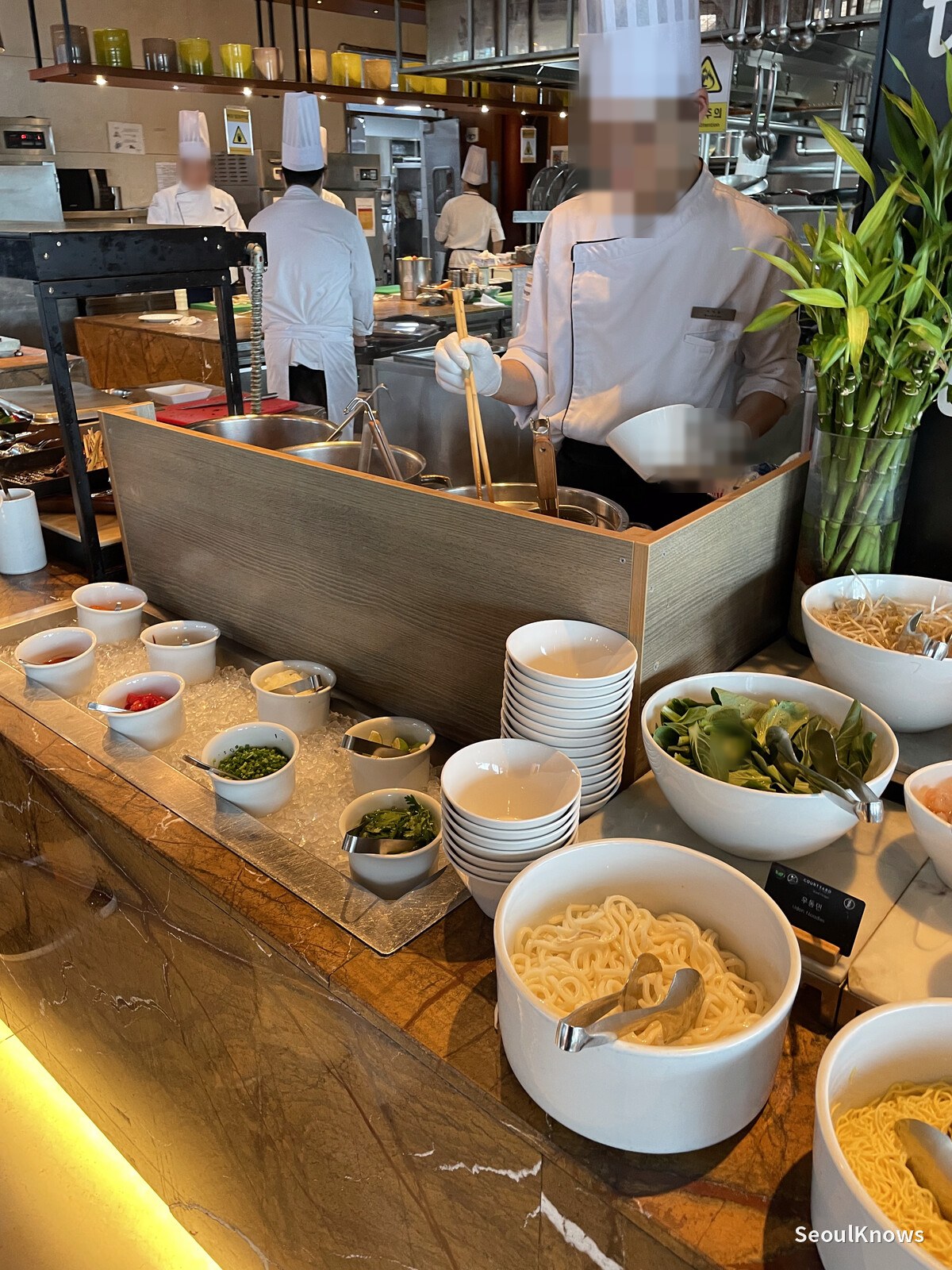 Chef cooking noodles to order at the MoMo Cafe buffet station