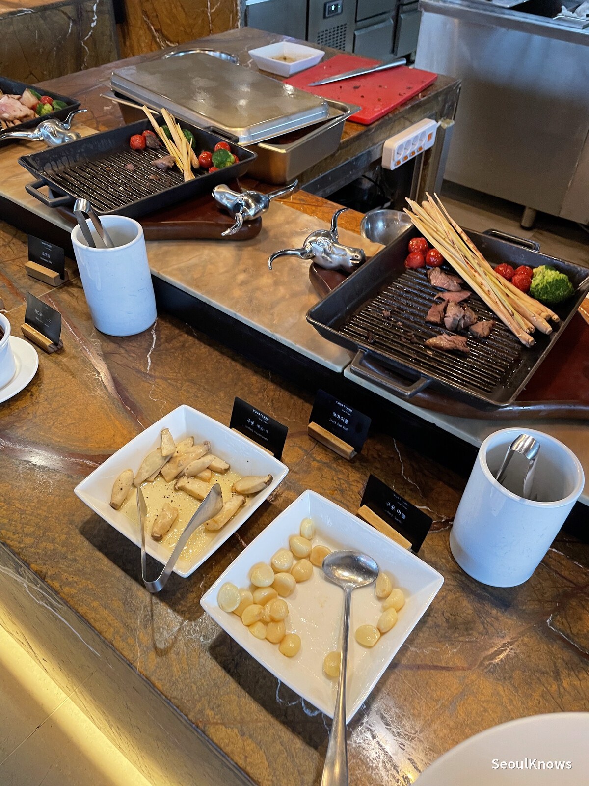 Grill station with roasted meat and vegetables at MoMo Cafe