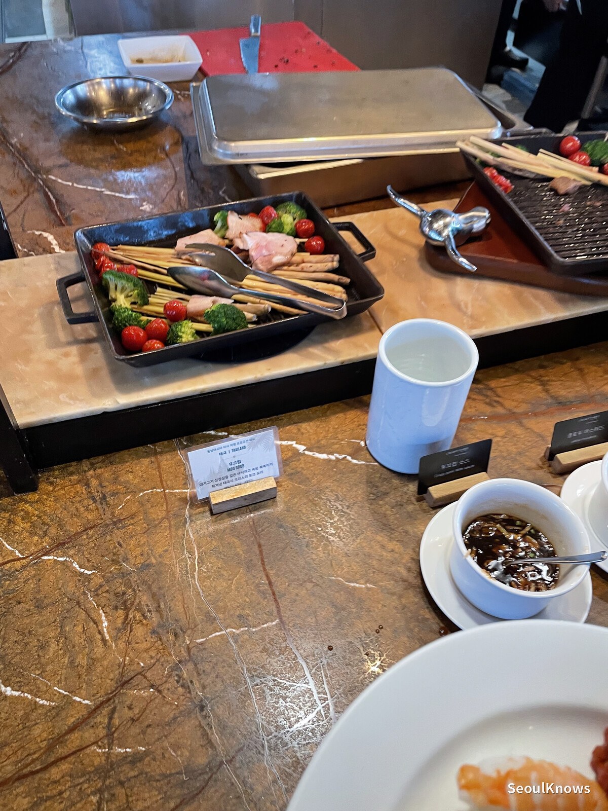 Grilled meat and vegetables served on a pan at the buffet