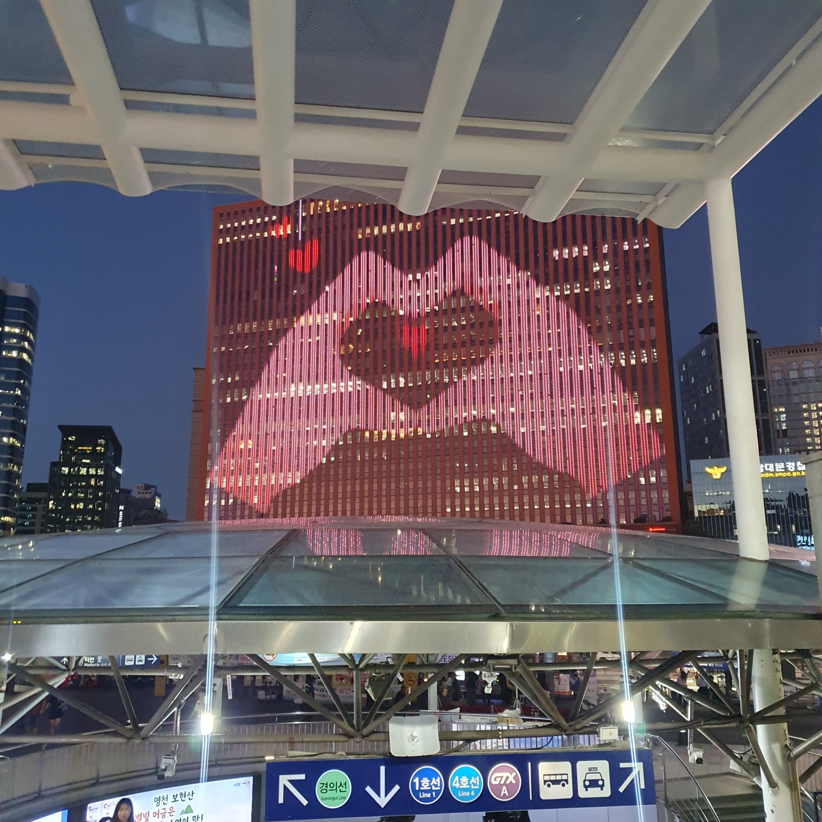 Seoul Square media facade finger-heart animation in front of Seoul Station