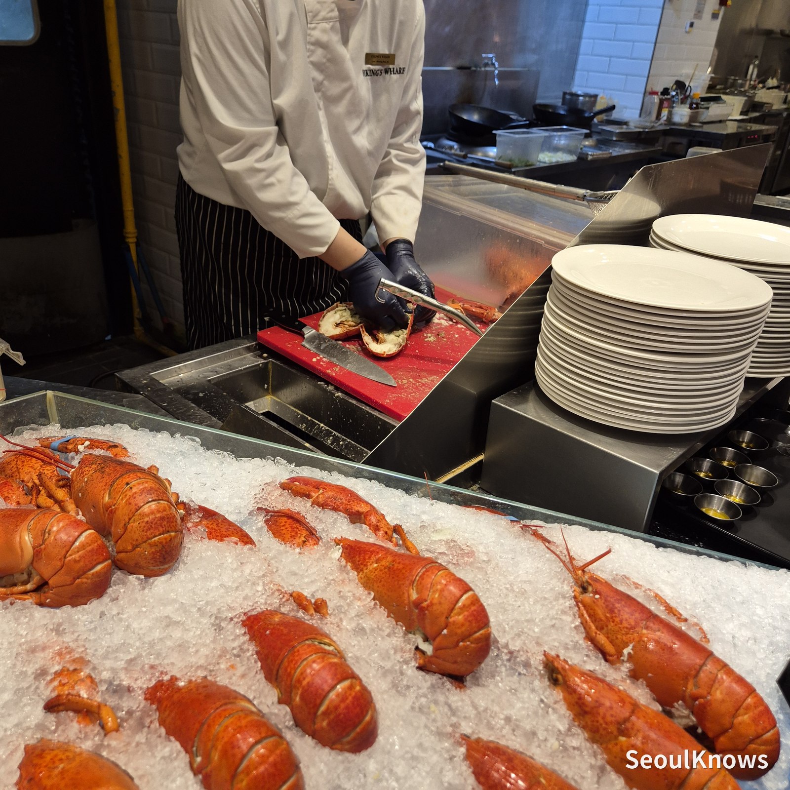 Staff member shelling a lobster to order at Viking's Wharf
