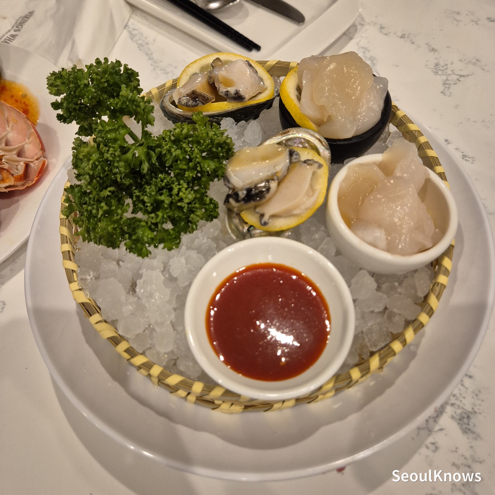 Raw scallop, abalone and clams on ice at Viking's Wharf COEX