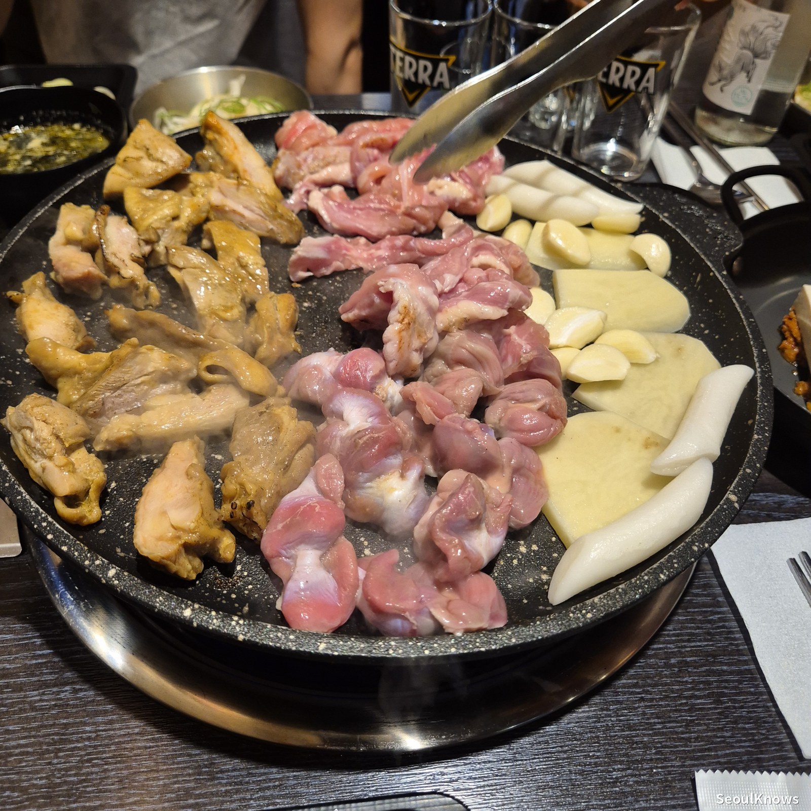 Wolgyerang signature set on the stone griddle with chicken gizzards garlic and rice cakes