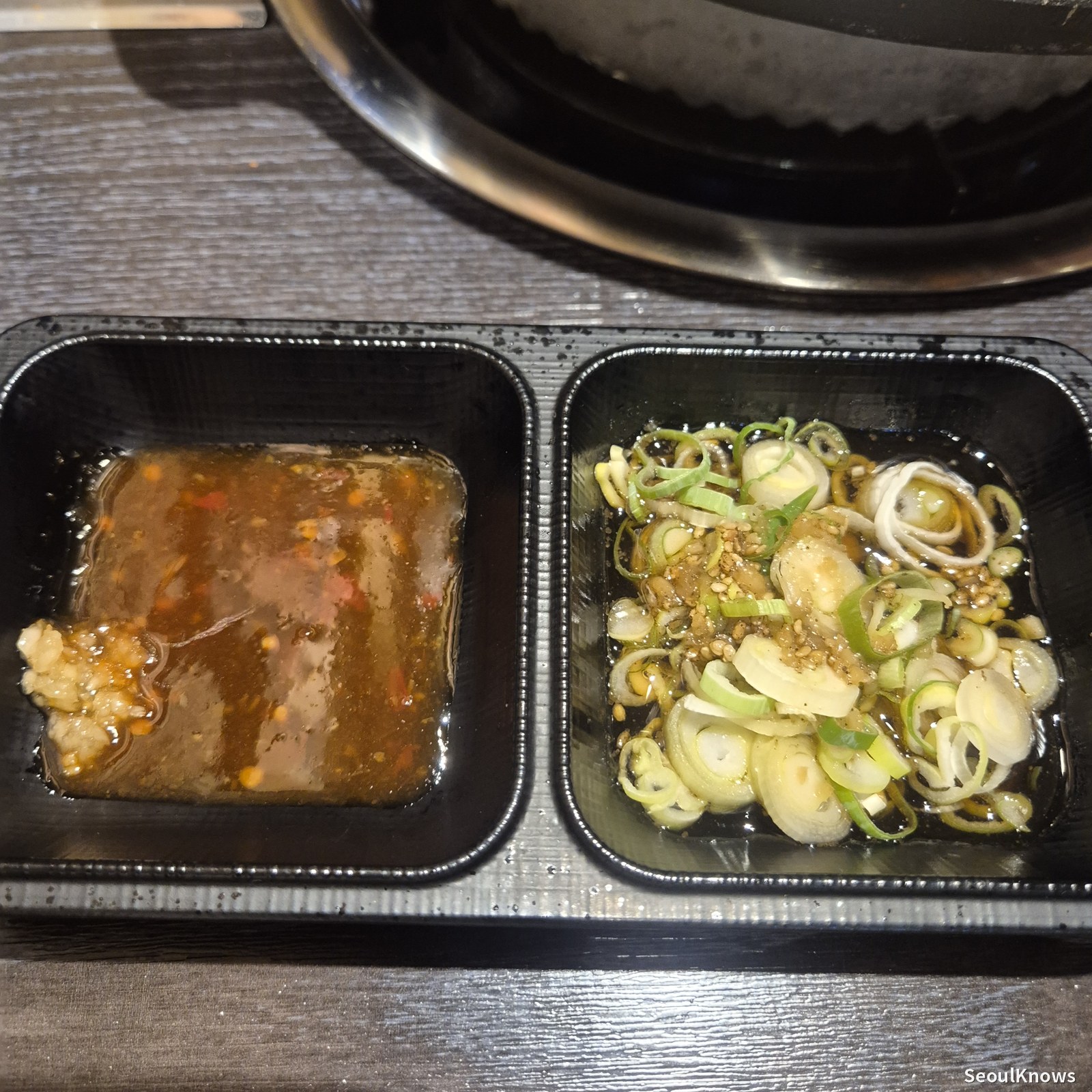 Dipping sauce and scallion salad served with the set