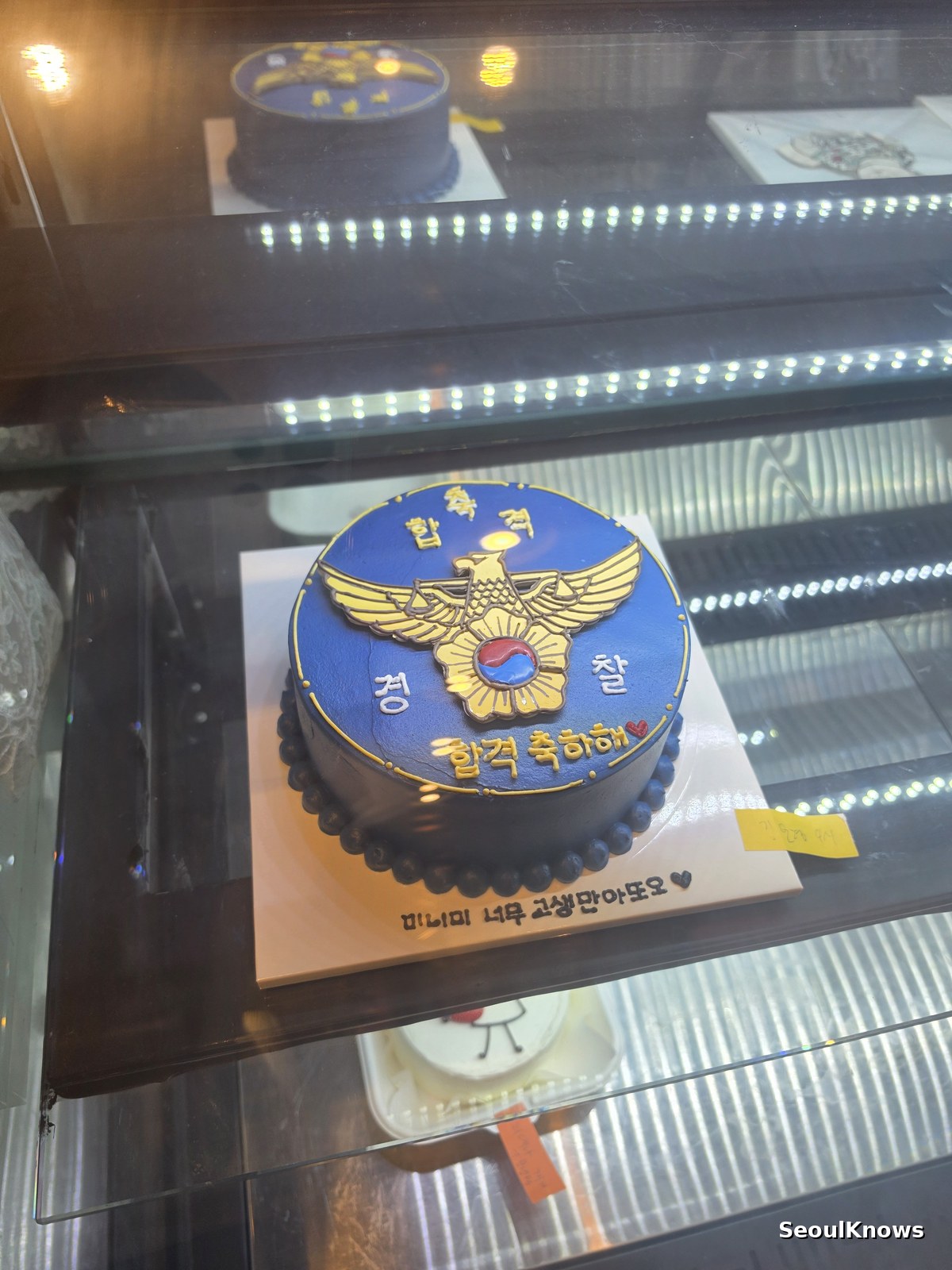 Custom decorated cake with a police emblem design in a Korean bakery