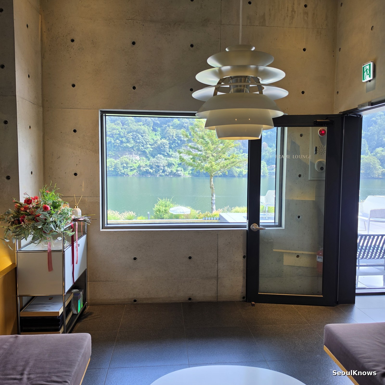 Square picture window framing the North Han River at Golden Tree cafe