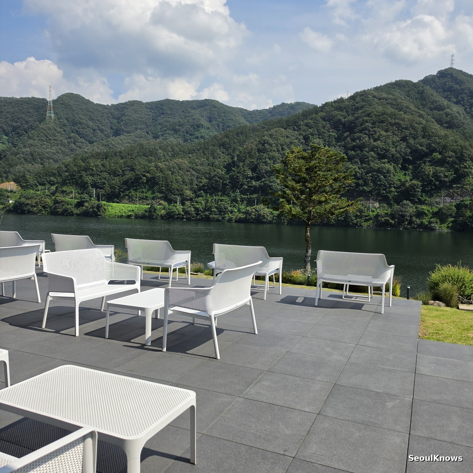 Outdoor terrace furniture overlooking the river at Golden Tree Gapyeong