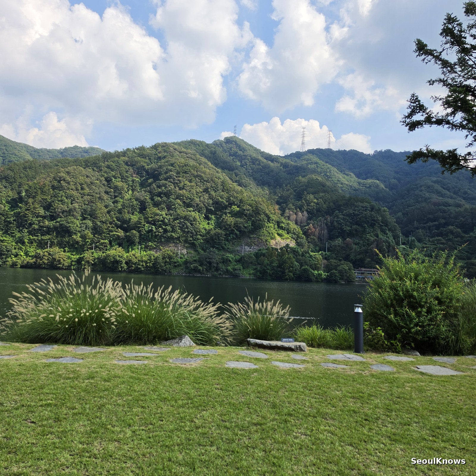 View across the lawn to the North Han River and mountains at Golden Tree