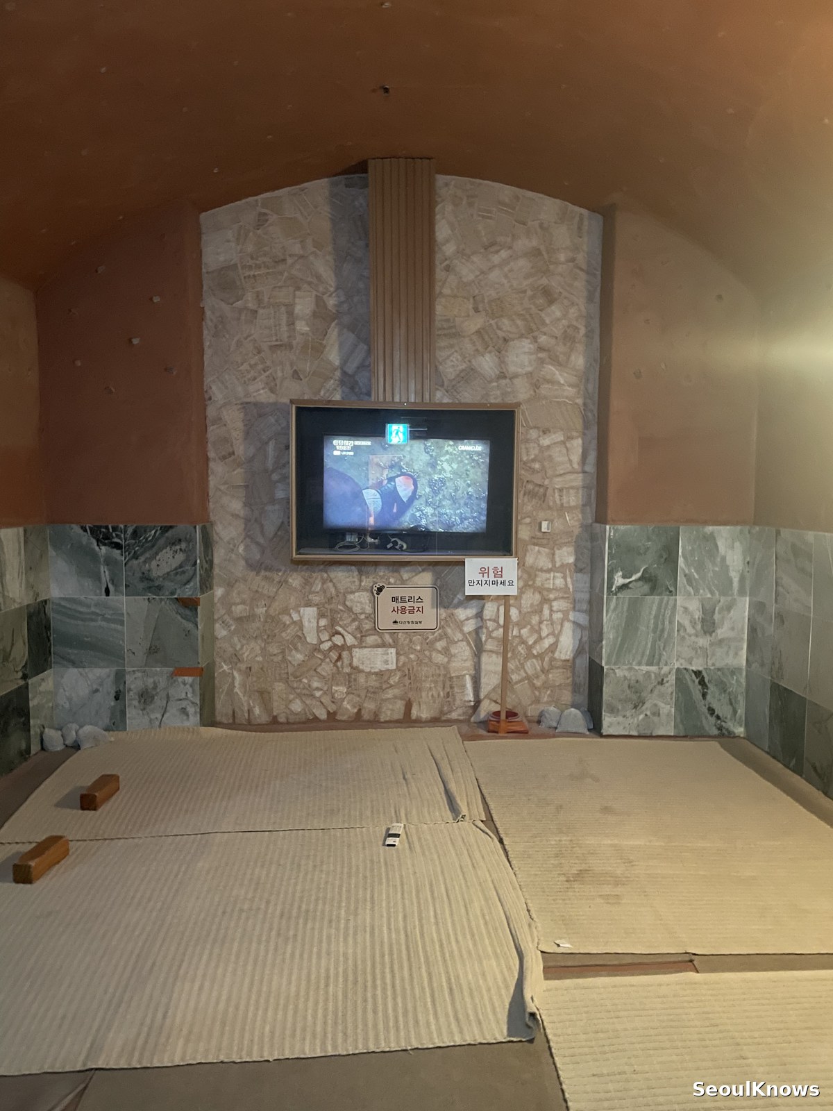Inside a warm sauna room with a screen