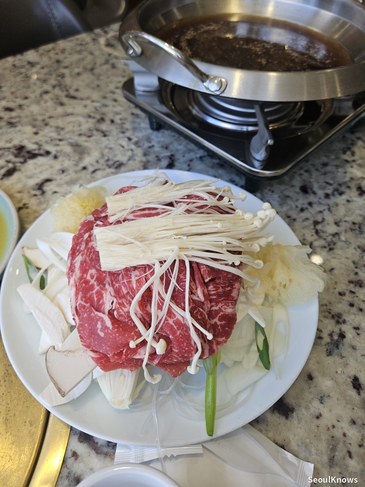 Raw hanwoo beef bulgogi with mushrooms before cooking