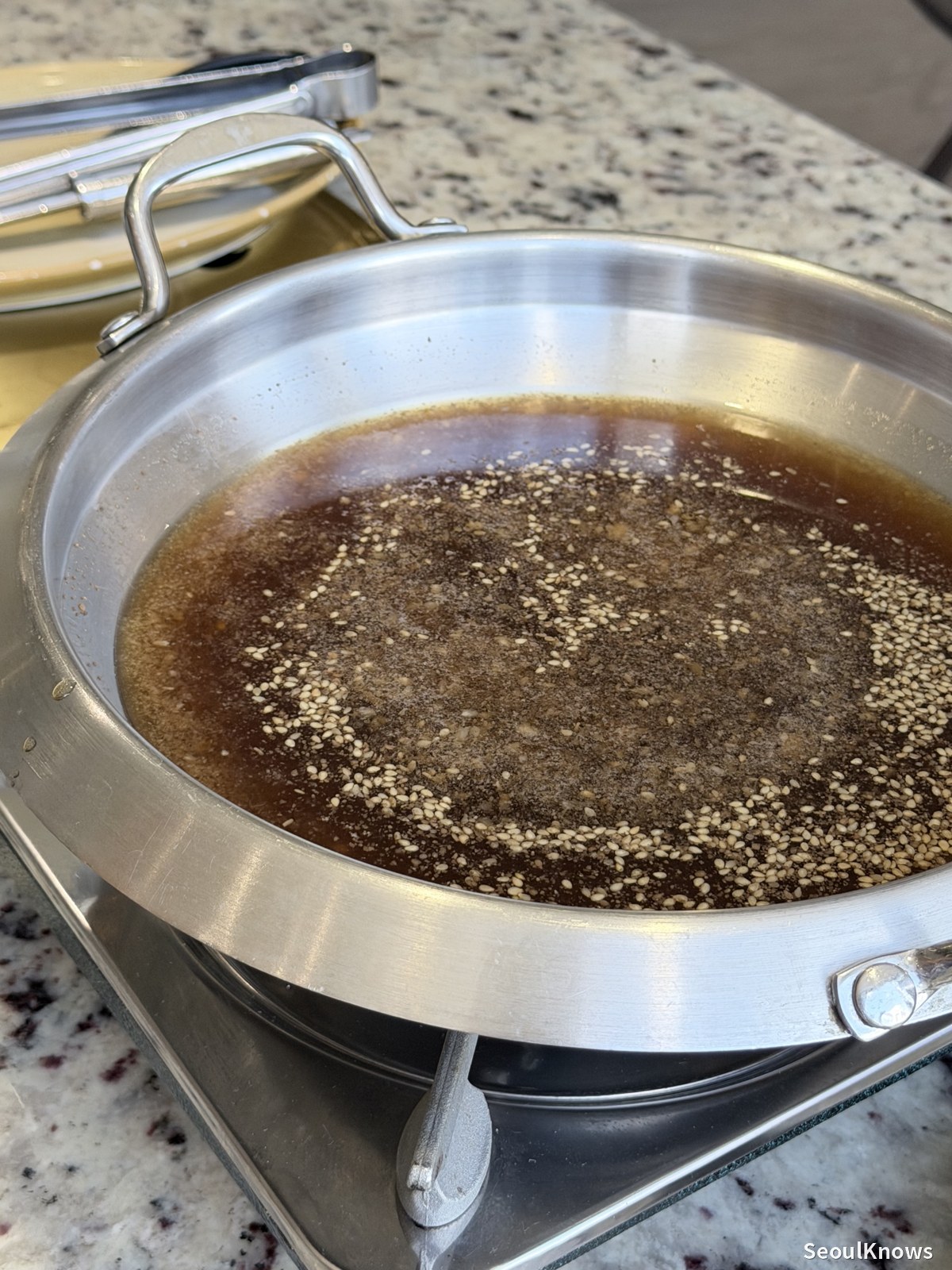 Soy based broth simmering in the bulgogi pan