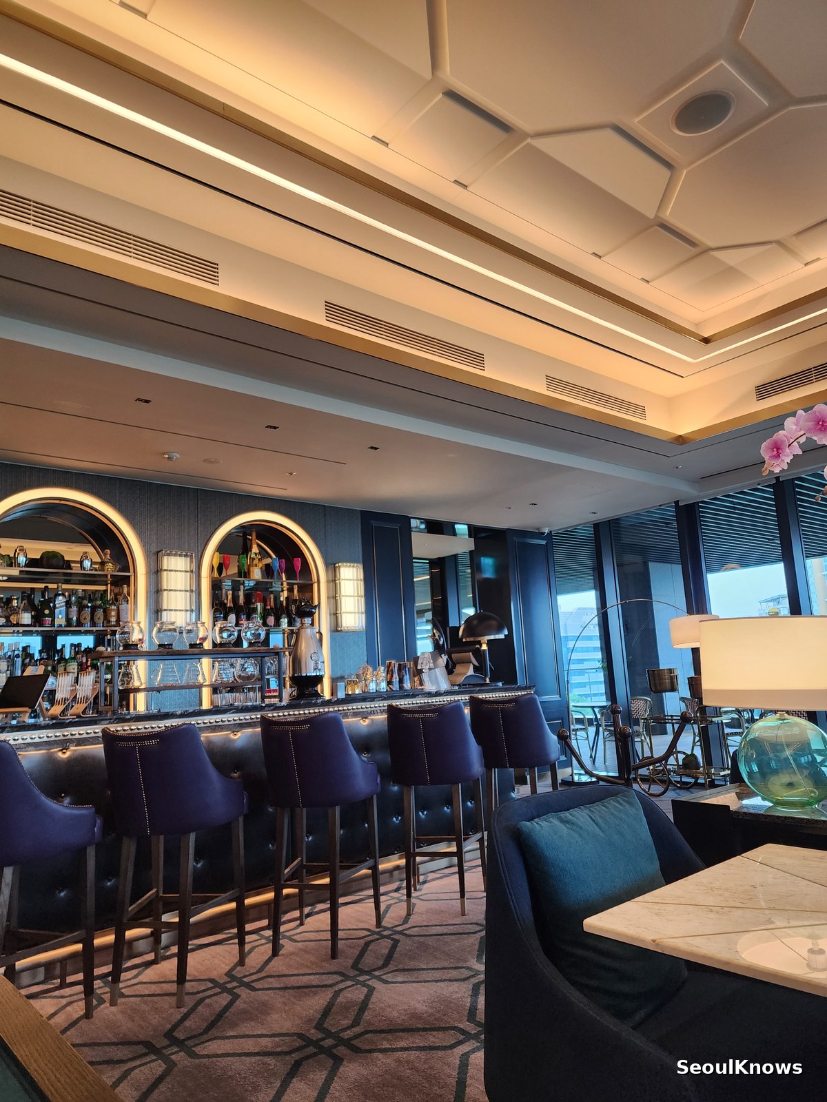 Dark marble bar counter with gold detailing at L'Espace lounge in Seoul